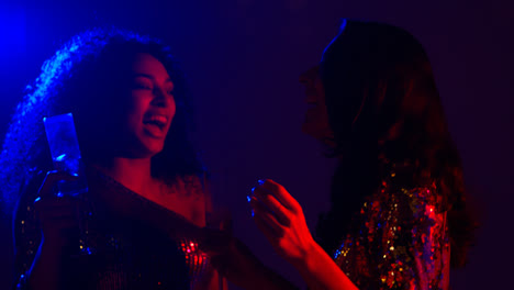 Close-Up-Of-Two-Women-In-Nightclub-Bar-Or-Disco-Dancing-And-Drinking-Alcohol-5